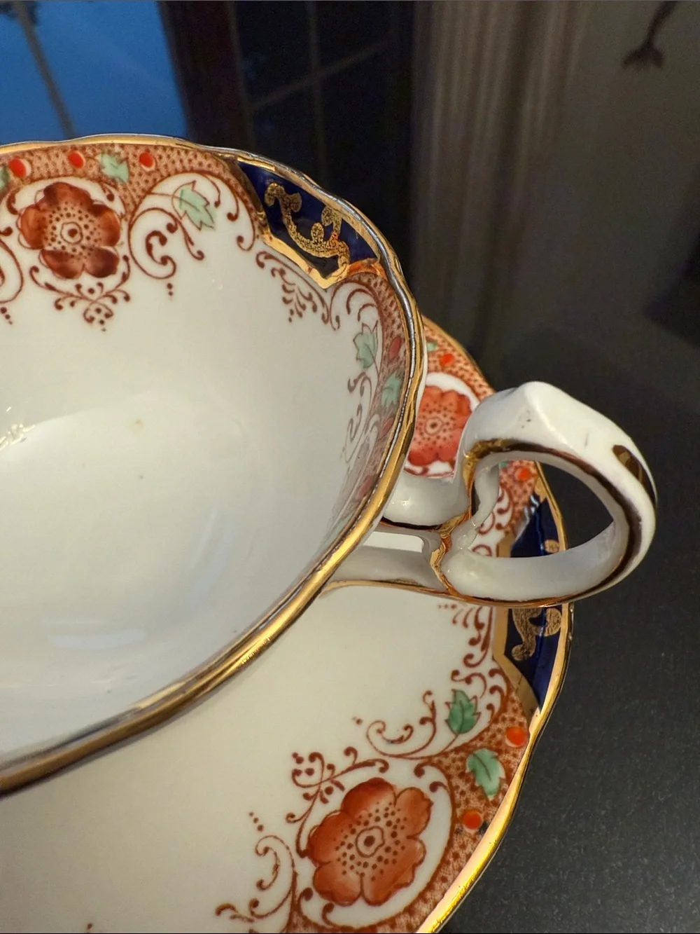 Decorative White and Navy Porcelain Tea Cup with Gold Accents